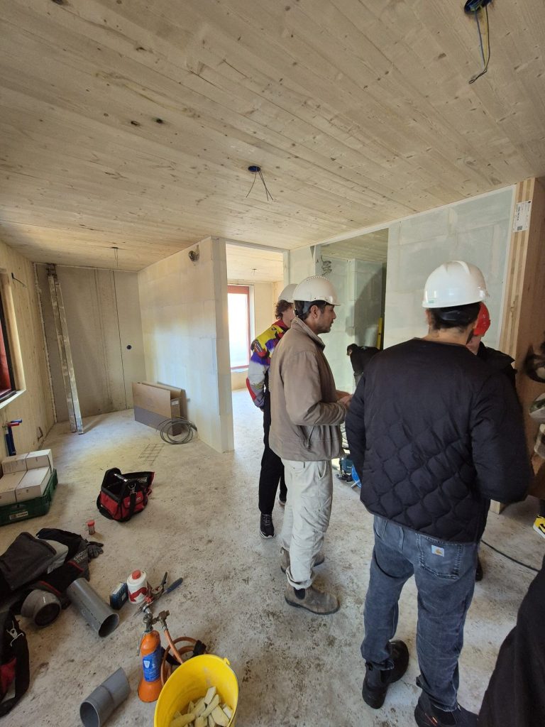 A site visit in hard hats inside the timber structure