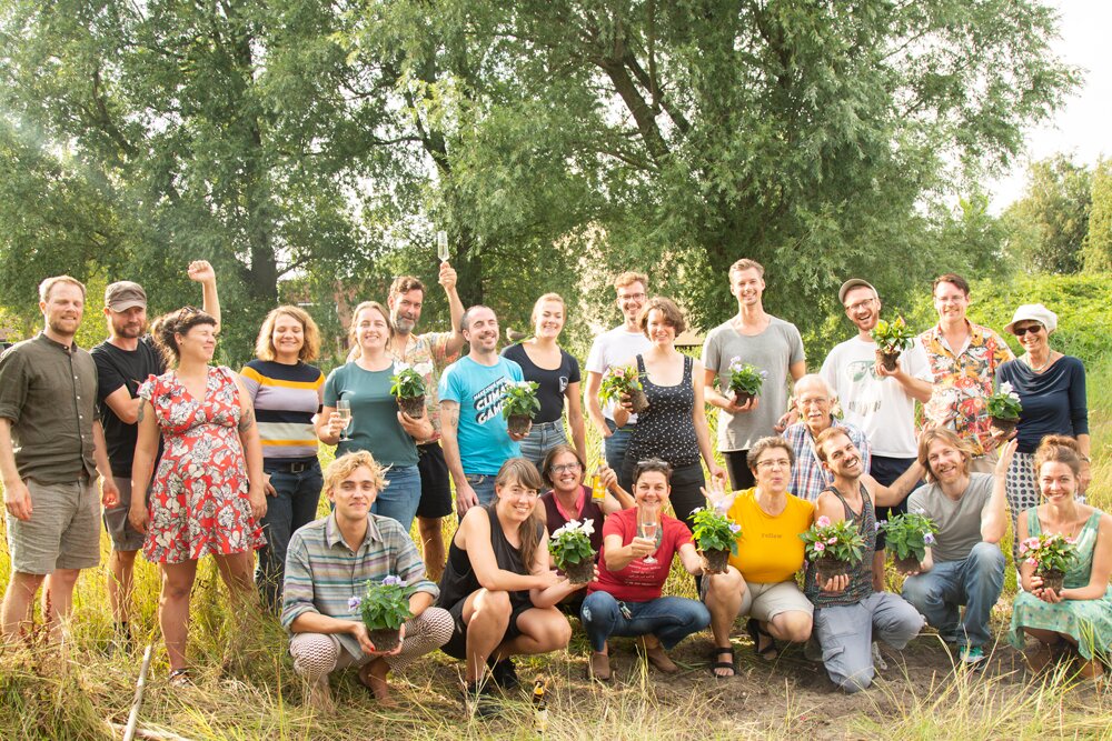 A large group of members posing outdoors in summer