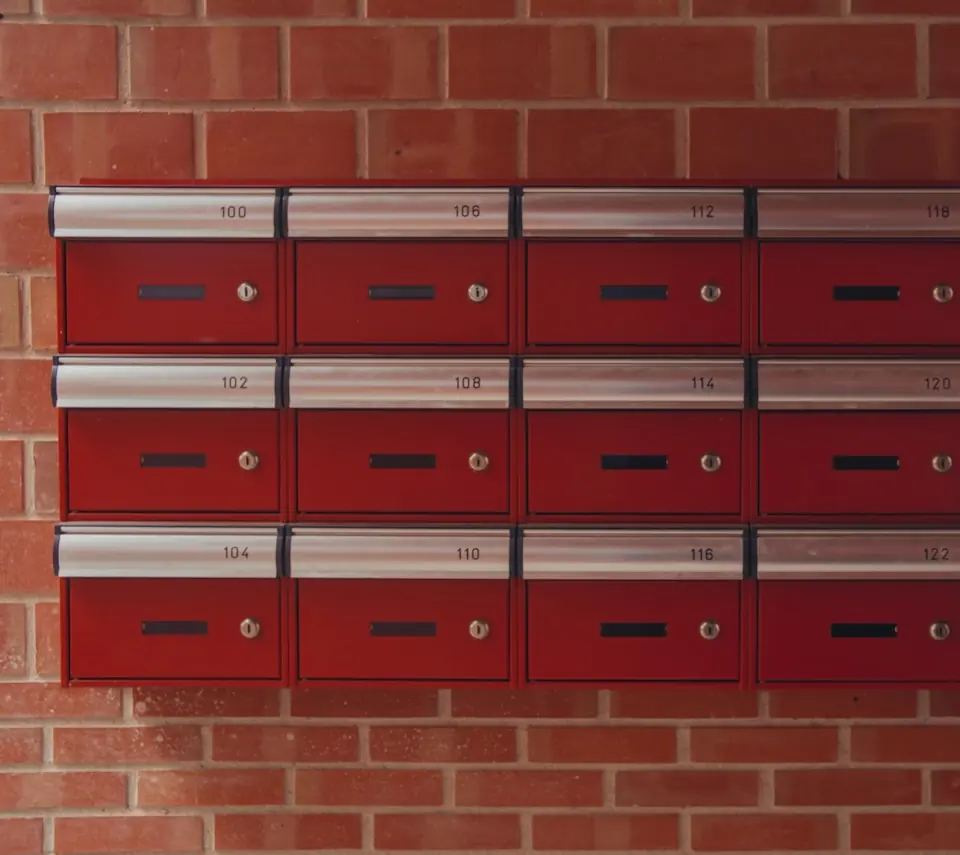 The red mailboxes in the entrance hall, numbered by home