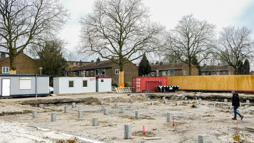 The building site with site huts and foundation piles