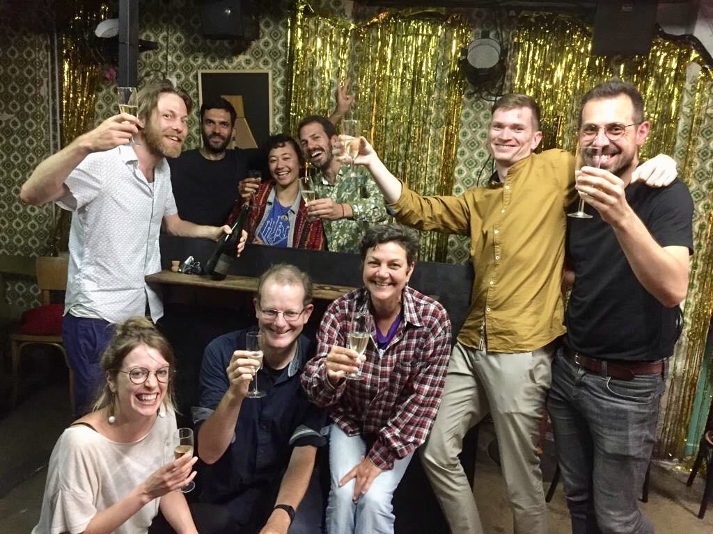 Members raising a toast after winning the tender, July 2019